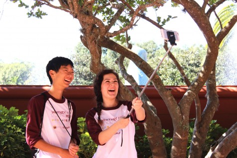Olivia Grahl and Ben Kim take a selfie with their selfie stick. Photo by Sierra Young