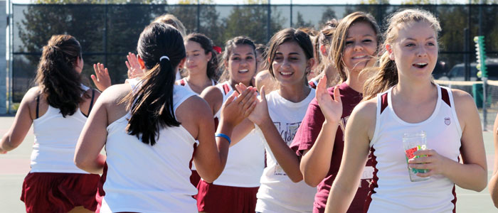 Tennis team gathers to announce the line up before a game. Photo by THANH PHAN