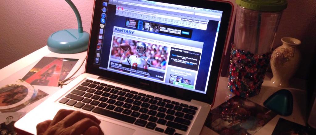 Kaitlyn Townsley scrolls through a fantasy football website
