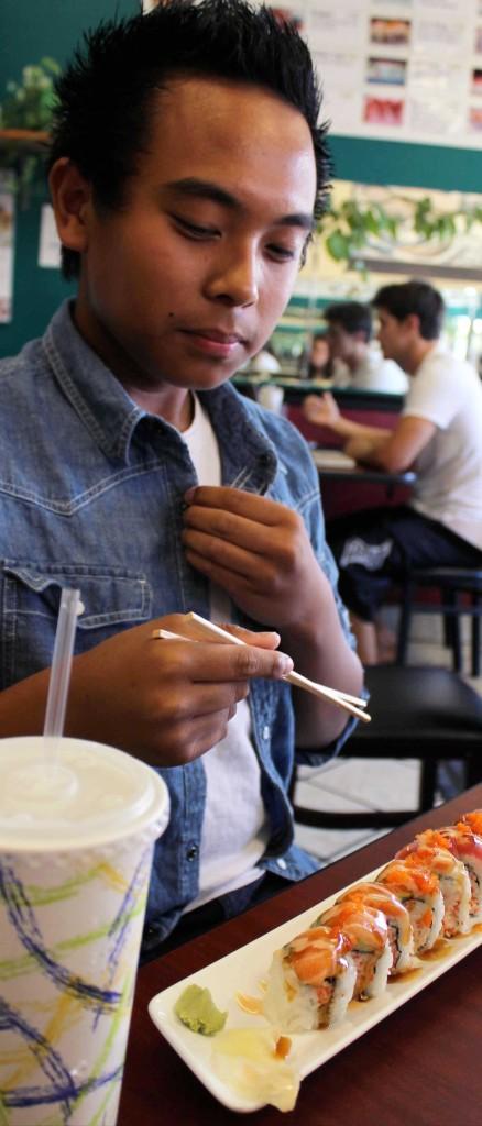 Kenneth Villorente attempting his first bite of sushi. 