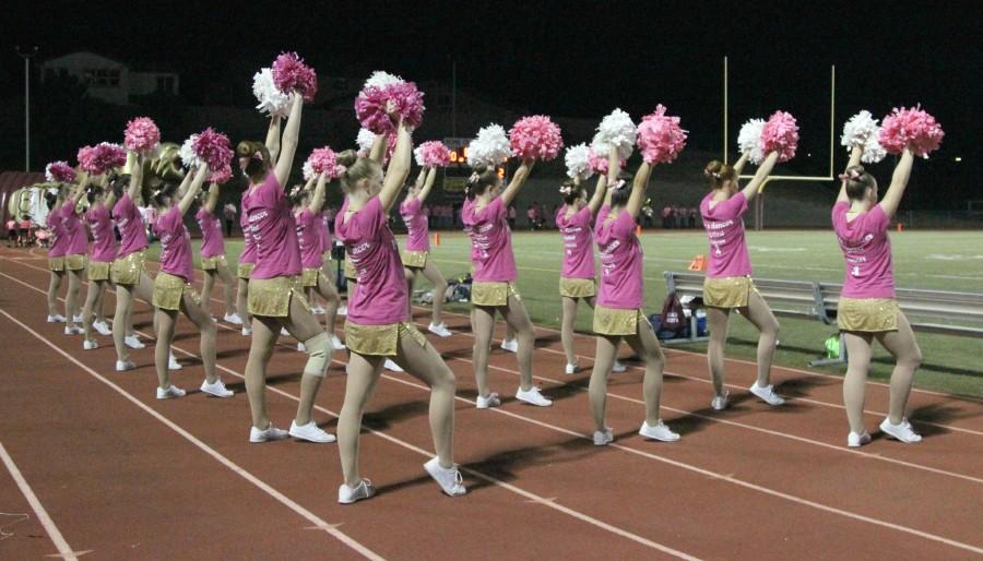 The dance team shakes their poms during the kickoff. Photo by Rylea Gillis.