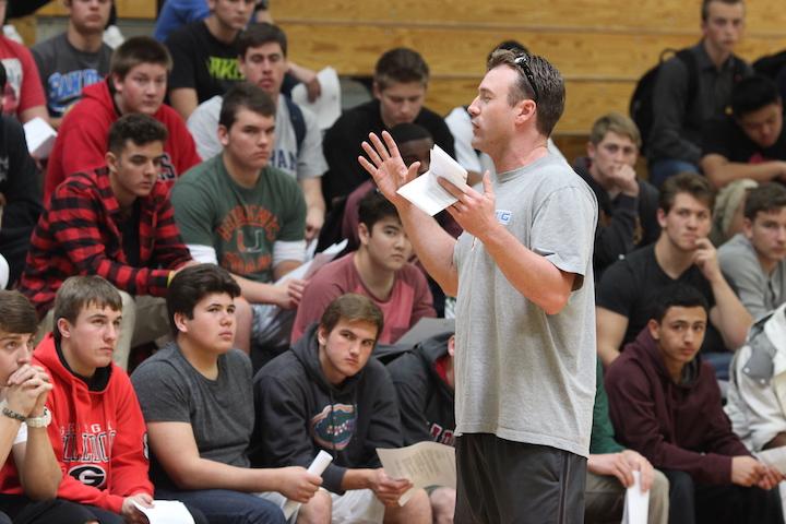 New varsity head coach Paul Doherty speaks to returning football players on Feb. 27 about upcoming practices. Photo by Ariella Appleby