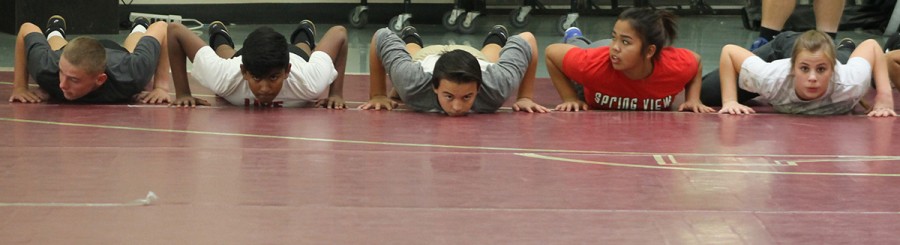 Wrestlers warm up before practice