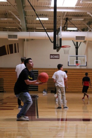 Elmo Canlas shoots a basketball during team sports. 