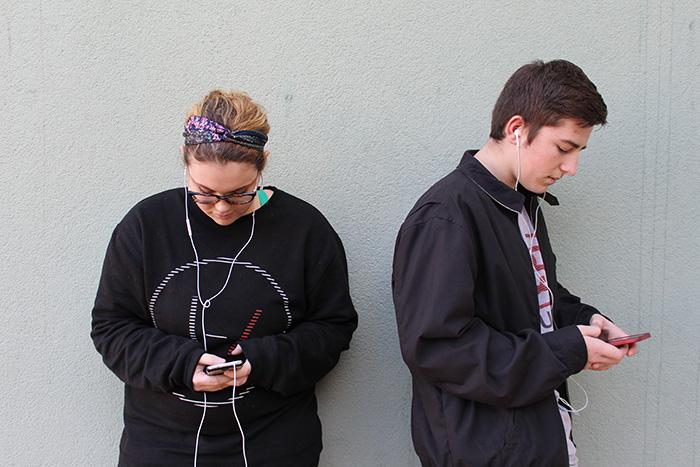 Morgan Jones and Trevor Gross go through their music on their phones. Photo illustration by Rachel Marquardt