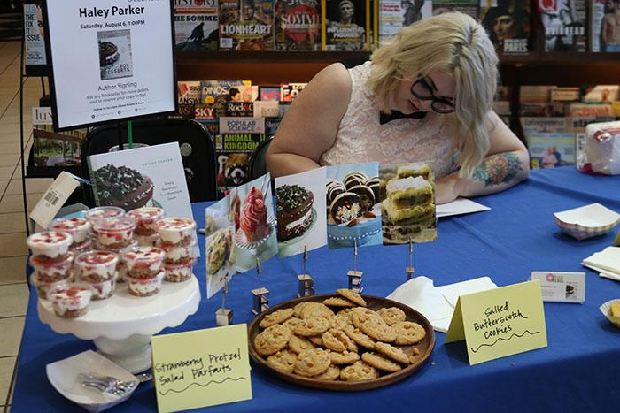 Hayley Parker autographs her cookbook for a fan at the "Out of the Box Desserts" book signing in Barnes and Noble. Photo by Morgan Hawkins.