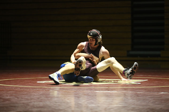 Men’s varsity wrestler Maverick Chadwick battles in his match during the scrimmage against Lincoln before the season starts. Photo by Elizabeth Salvato.
