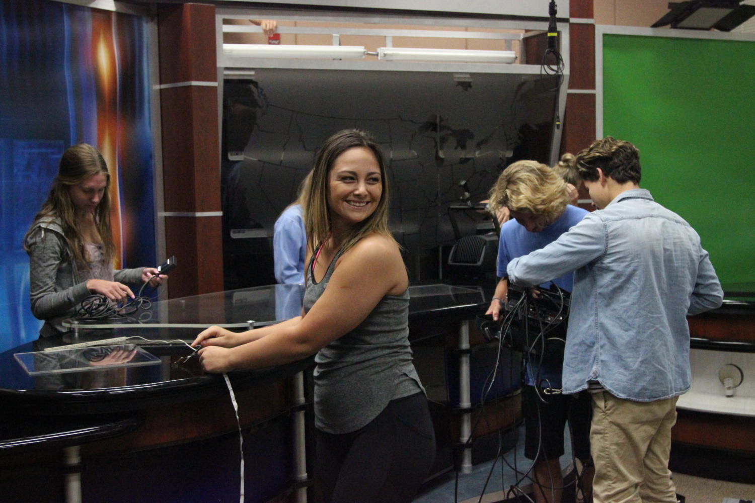 During an editors’ meeting Aug. 10, Meghan Townsley, Kylie Thompson, Evan Risucci and Dylan Smith work on setting up new equipment donated by KCRA 3. Photo by Britney Flint.