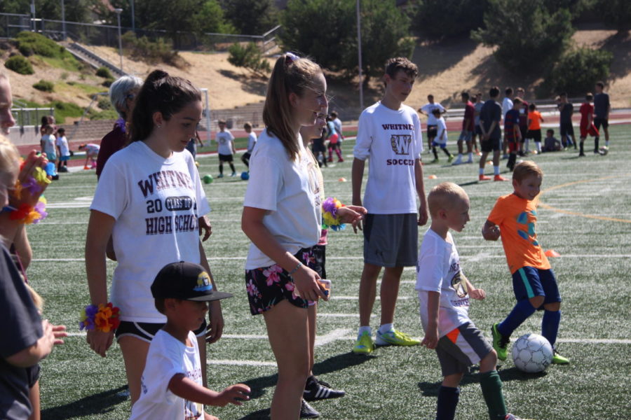 During the Whitney Kids Camp on July 24, Maddy Cortez, Mikayla Barkve and Connor Hedman practice passing with the participants. Photo by Britney Flint. 
