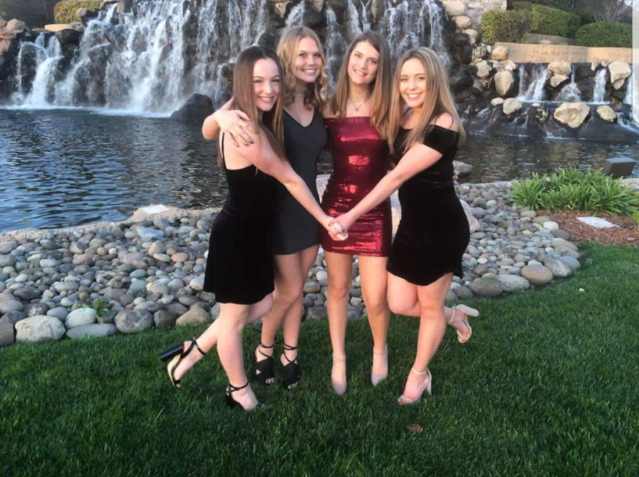 At the Lincoln Hills Golf Course entrance, Kyleigh Boatwright, Madilyn Sindelar, Giorgia Magnani and Morgan Choffin pose for pictures before Winter Ball. Photo by Kym Sindelar.