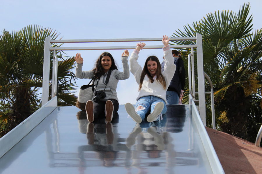 As subjects for photography practice, Emma Accacian and Arianna Rasooli go down a slide at Mission Dolores Park. Photo by Zoey Cummings.
