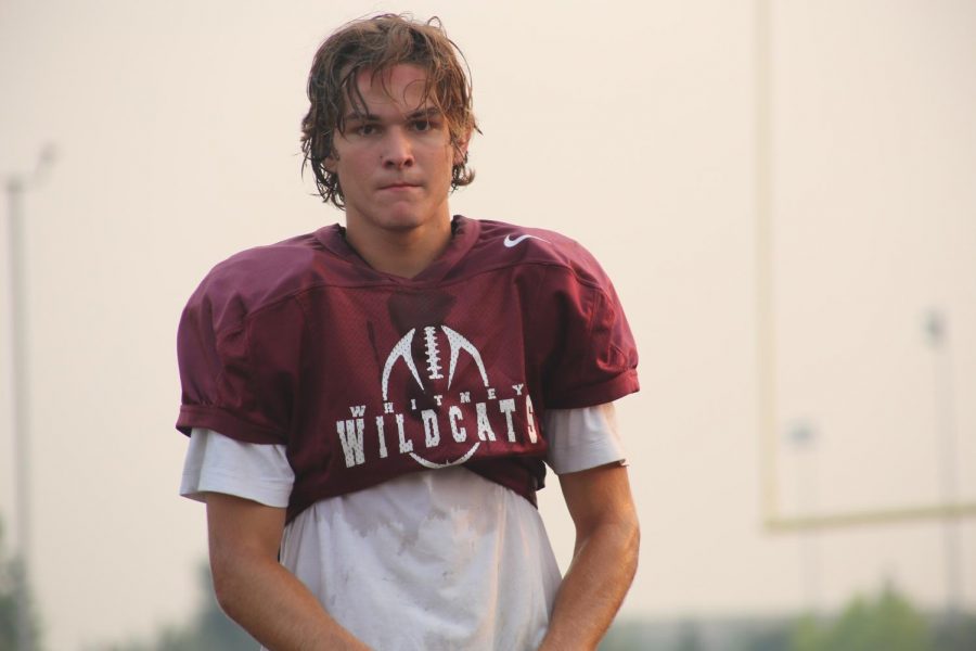 During a water break, Nicholas Miller stands on the field surrounded by the smoky air. On Aug.  7, during practice at 6 p.m., the varsity and JV football players practiced in 88 degree temperature while the air quality was at 90 AQI.