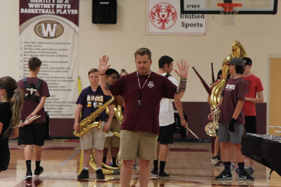 During band camp, Aug. 8, Mr. Kasey Searles instructs his students on where and when to stop marching, in preparation for their competitions. Photo by Emma Accacian