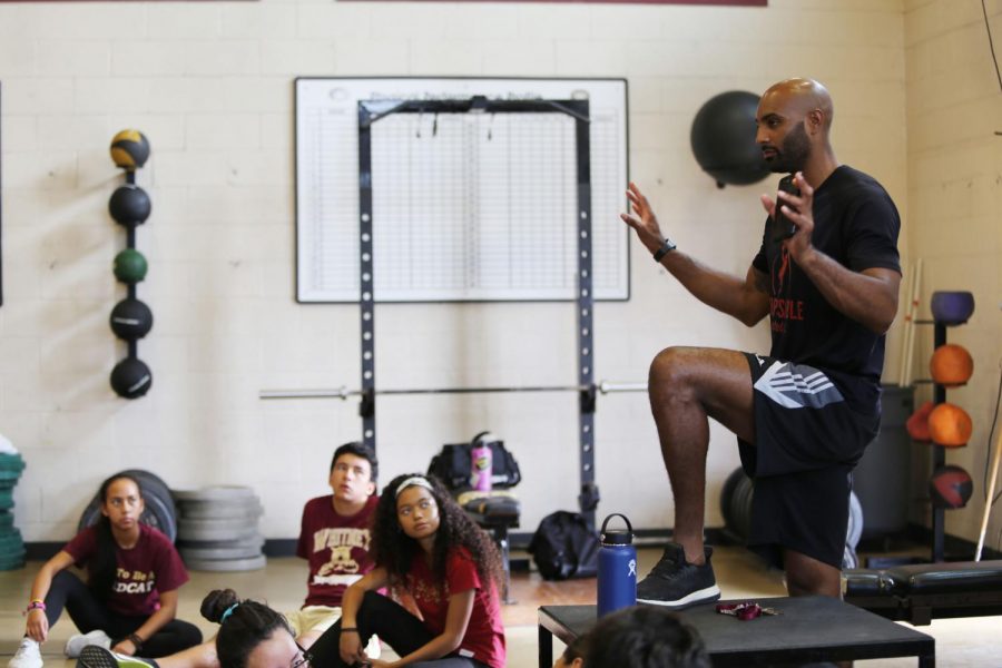 During second period weights training, Mr. John Pichon discusses his goals for the class with his students by explaining the purpose of their workouts. Photo by Aviana Loveall.