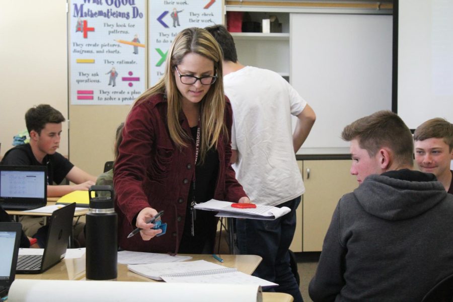In Ms. Ashley Chaney eighth period Integrated II class, she stamps Eli Brickhandler’s homework. Photo by Payton Arthur.
