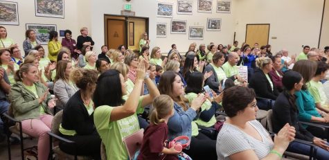 Teachers clap and cheer after hearing a fellow educator share her story working for the district. Photo by Alaina Roberts. 