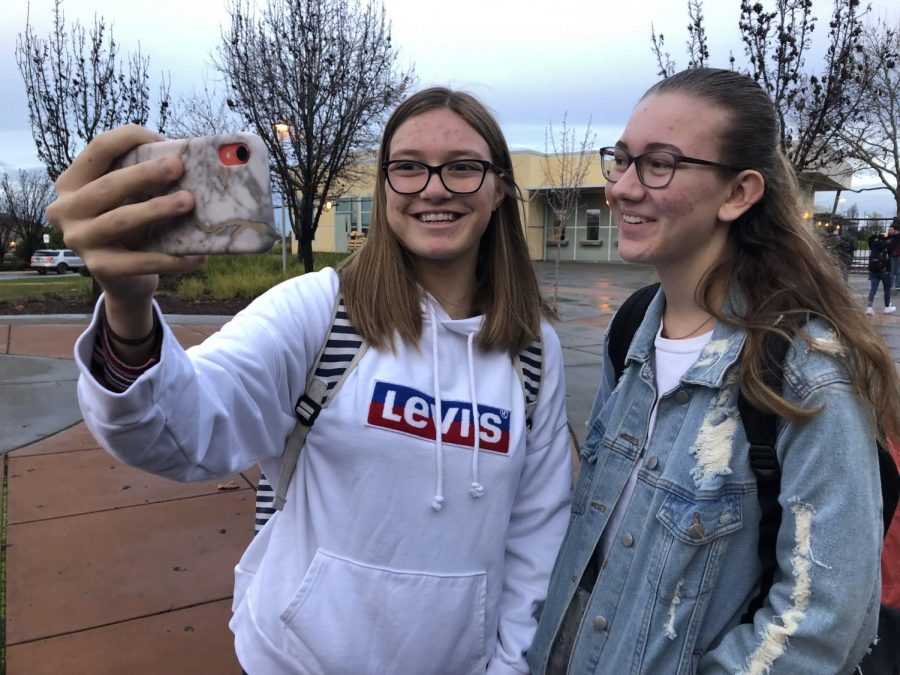 Before school on Jan 9., Joy Jeung and Summer Hensley film a vlog about their daily school life. Photo by Alicia Cho 
