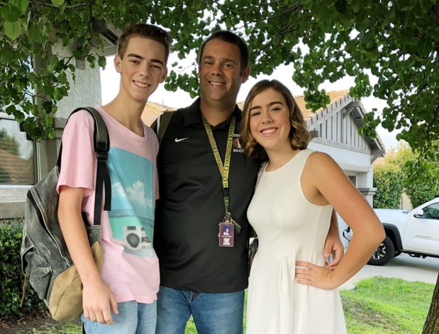 On the first day of school, Mr. Joel Williams poses with his children Jonah and Julia before heading to Whitney High School. Photo courtesy of Julia Williams. 
