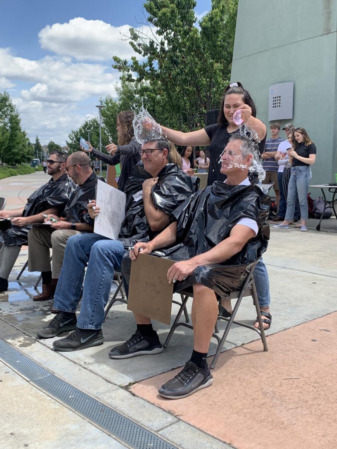 At the “Twin Day” LTA May 23, Kylee Jo pops water balloons over Mr. Paul Hanks and Mr. Mike Gimenez’s heads after they incorrectly answered a question about the school year’s history. Photo by Adriana Williams.