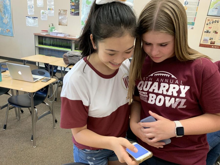 In Mrs. Seabrook’s room during lunch, Abigail Root and Allyson Ikeda use the 5-Star Student App to vote for Homecoming Royalty. Photo by Olivia de Lamadrid