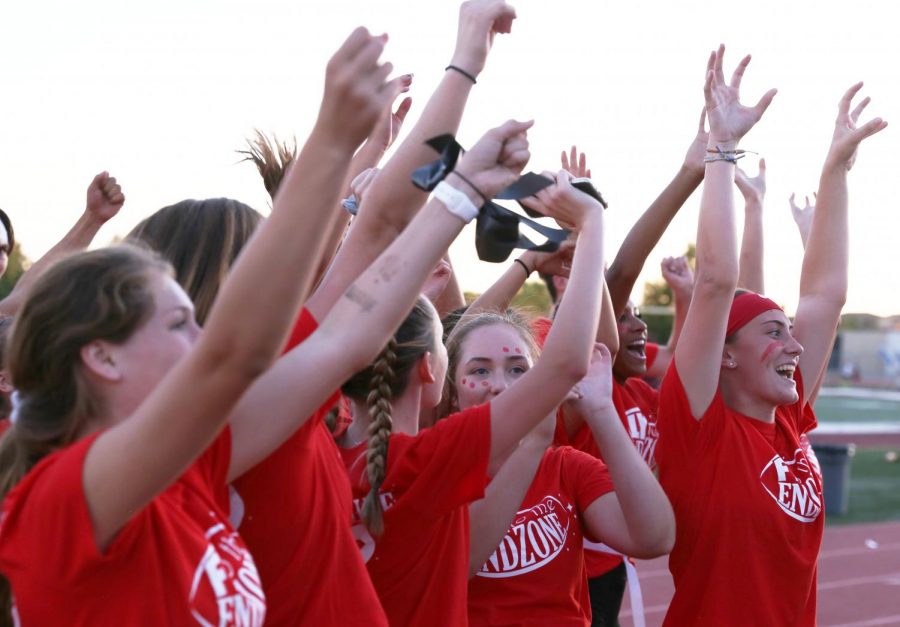 Before the freshman versus sophomore game, sophomore powder puff players cheer on the sidelines. The underclassmen played Sept. 23 at 6 p.m. Photo by Dylan de Valk. 