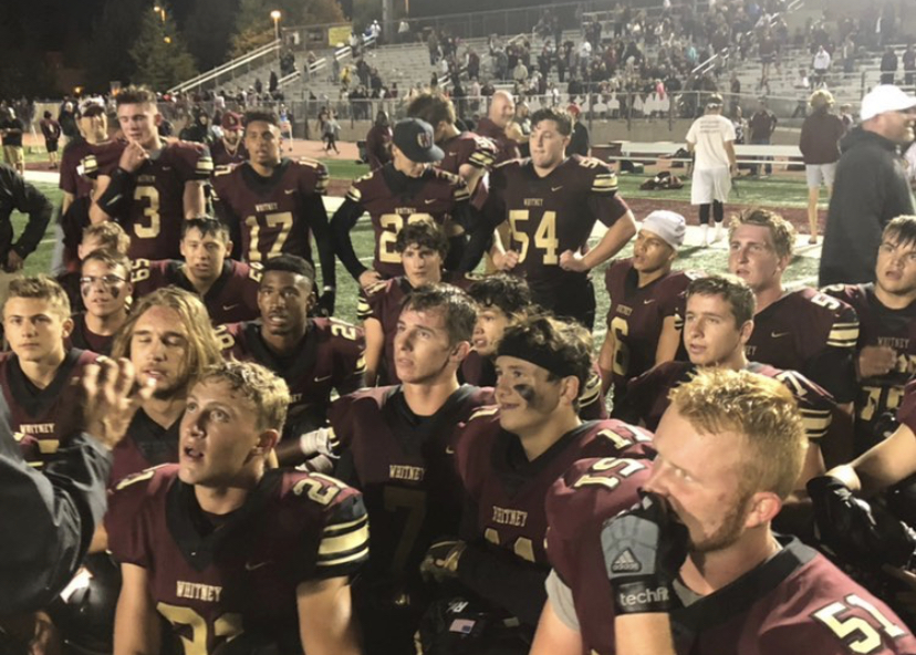 After+the+varsity+football+game+against+Del+Oro%2C+the+team+takes+a+knee+to+listen+to+Coach+Zac+McNally%E2%80%99s+reactions.+The+Wildcats+won+30-27+in+overtime.+Photo+by+Aazam+Khan.