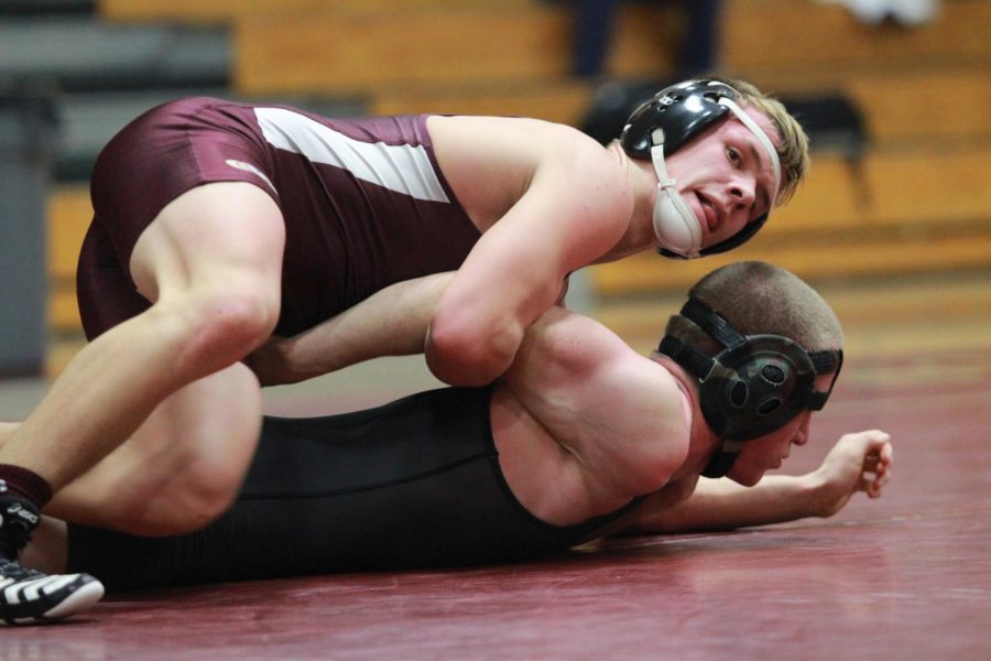 Wrestling captain, Isaiah Schannep attempts to take down his opponent.