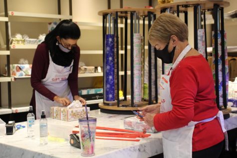 Local volunteers wrap gifts Nov. 27 as part of the Bayside gift wrapping station in the Westfield Galleria mall. 


