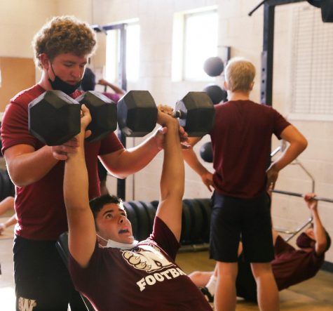 In preparation for the Quarry Bowl, varsity football players Cole McCracken and Ben Counter complete their last set of weight training. Photo by Benjamin Lynn.