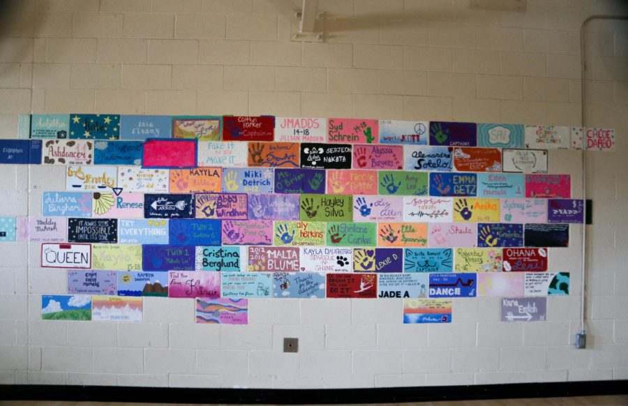 The+furthest+wall+of+the+dance+room+is+covered+in+hand-painted+bricks+by+students+who+graduated+after+completing+the+dance+program+with+Mrs.+Halley+Crandell+and+Mrs.+Mallory+Ansley%2C+who+are+both+stepping+down+as+coaches+beginning+in+the+2022-23+school+year.+Photo+by+Maya+Gomez