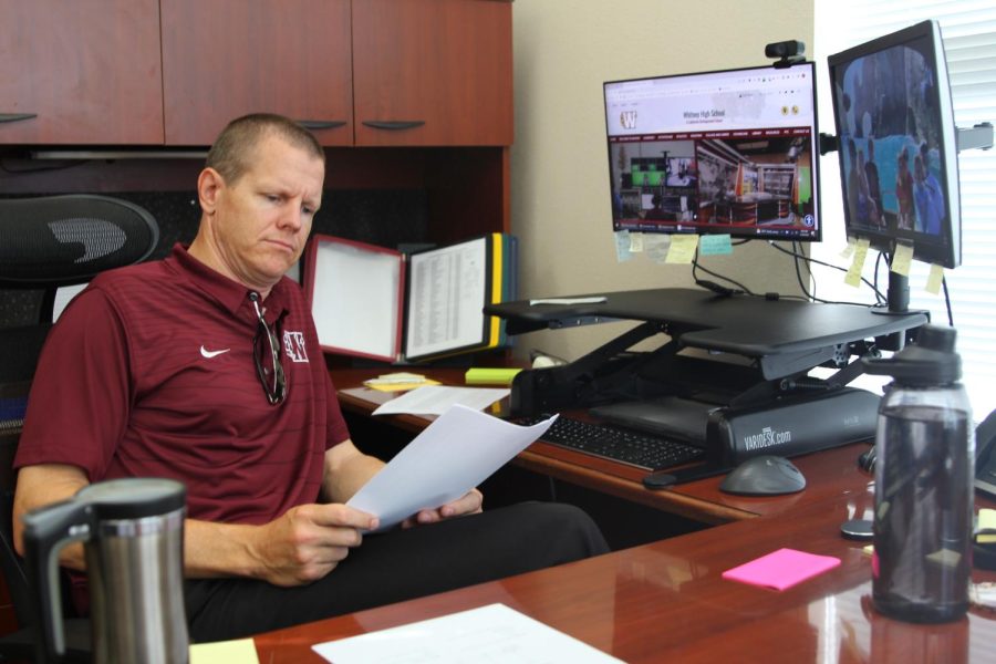 Working in his office July 28, Principal Scott Collins adapts to his recently-acquired position and plans for the upcoming school year. Photo by Kaitlyn El-Sayegh