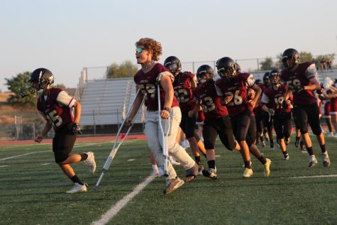 After their 19-0 win against Chico Sept. 16, Sam Harmon and the JV football team rush down the field to celebrate their third win after a home game. Photo by Natalie Deeble.
