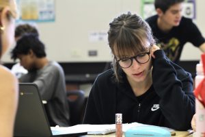 In E-8 during fourth period, Carola Pastore studies for her Chapter 3 AP Biology test Sept. 14. Pastore said working with advanced scientific concepts in English rather than her native Italian has been one of the most difficult parts of her exchange. Photo by Maya Gomez