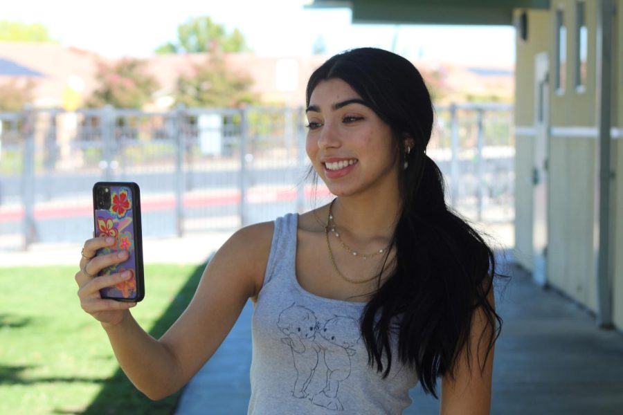 Outside of C-2, Nayeli Glaude takes a selfie on Snapchat to send to a friend during lunch Sept. 22. Photo by Alexis Dashnyam