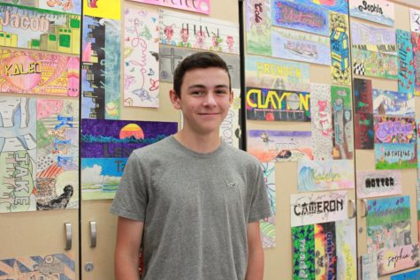 One of Cole’s favorite classes is ceramics, which is located in room C3. Behind him is a wall filled with the art students’ project on their names.