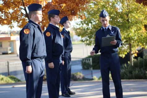 In front of the ROTC building Nov. 17, Cadet Senior Airman Alex Glasgow does a uniform check for his AS-1 flight. Photo by Isabel Soto
