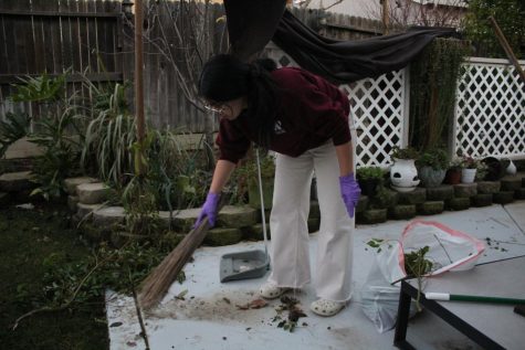 After severe storms hit her home in Northern California during the first two weeks of January, Francheska Pontillas sweeps up dirt and debris that had fallen in her backyard. Photo by Eiron Ordona.