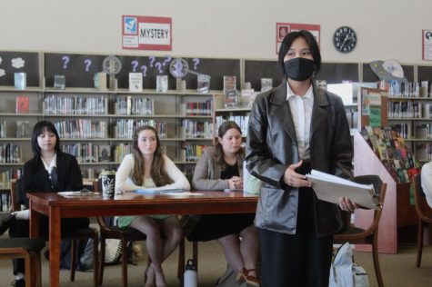During Mrs. Emilie Cavolt’s eighth period AP Language Arts class April 19, Sophia Punsalan delivers her speech to the “jury” – a panel made up of her peers – in an attempt to prosecute the “defendant,” Margaret Macomber, during the class’ Mock Trial project. Photo by Alexis Dashnyam