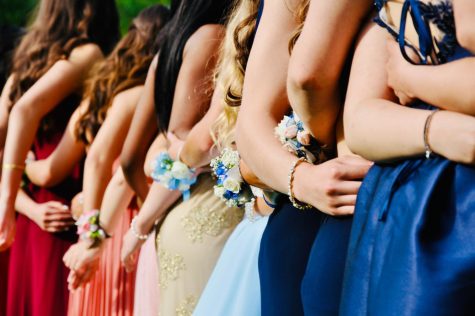 Dressed for a school dance, students pose for a photo outside. After discussion between school staff and junior class officers, it was decided that Junior Prom Apr. 22 would be held on campus in the small gym for the first time. Photo by Todd Cravens via Unsplash