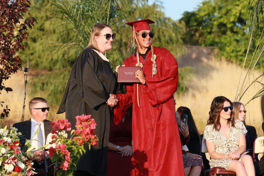 After stepping on stage to receive his diploma, Mrs. Jennifer Hanks and Jackson Floyd pose for a photo. After 18 years on campus, Hanks departed after she accepted a new position as an implementation specialist working for the California Coalition for Inclusive Literacy. Photo by Emerson Kibby.