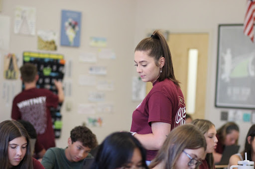 After finishing her lesson in her sixth period Language Arts I class Aug. 25, Ms. Tori Schlenz paces around the classroom. Following through with a job opportunity in the English department, Schlenz returned to her alma mater to pursue a career in education. Photo by Julia Leveron Hidalgo.