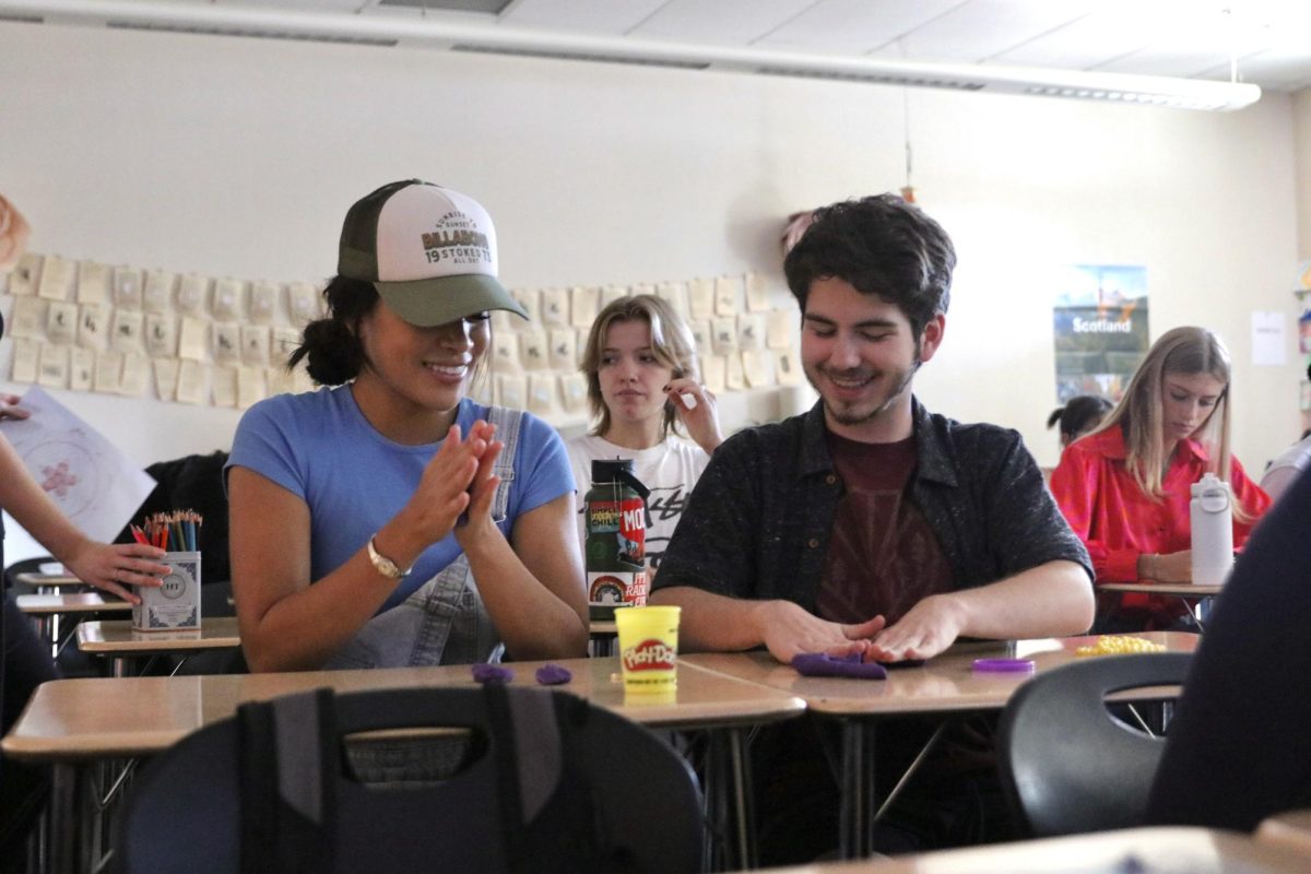 Before beginning their guided meditation in Mrs. Emilie Cavolt’s sixth period mindfulness class, Tiffani Vegaalban and Ryan Bollenbach play with Play-Doh as their “arrival” activity. The “arrival,” 10 minutes at the beginning of each class, is reserved for students to focus on themselves and their creative outlet by participating in a meaningful mindfulness activity of their choice. Photo by Alyssa Folmer.