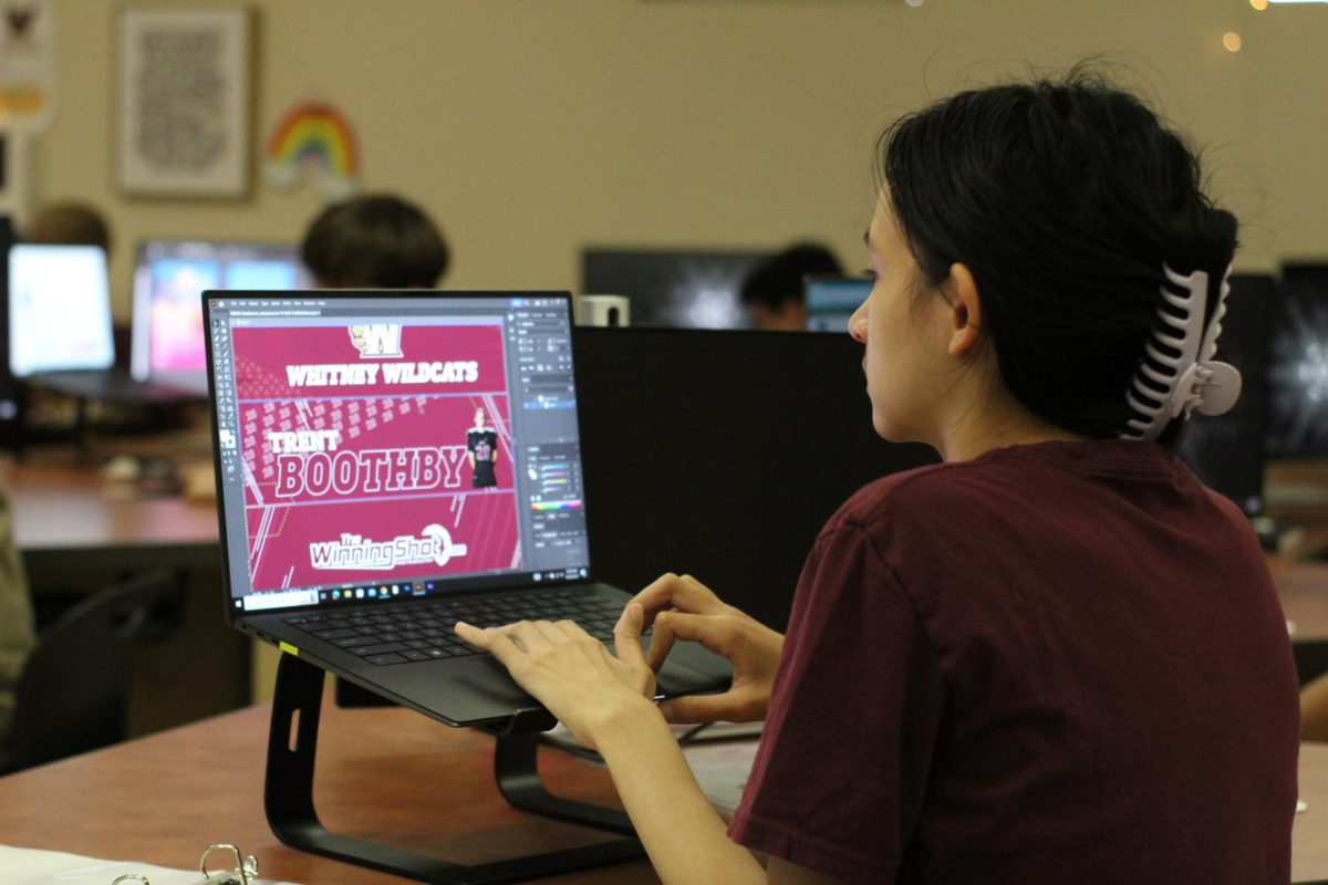 In fourth period Graphics III/IV, Lauren Seiler works on a video graphic for men’s varsity basketball. Photo by Reilynn Roux
