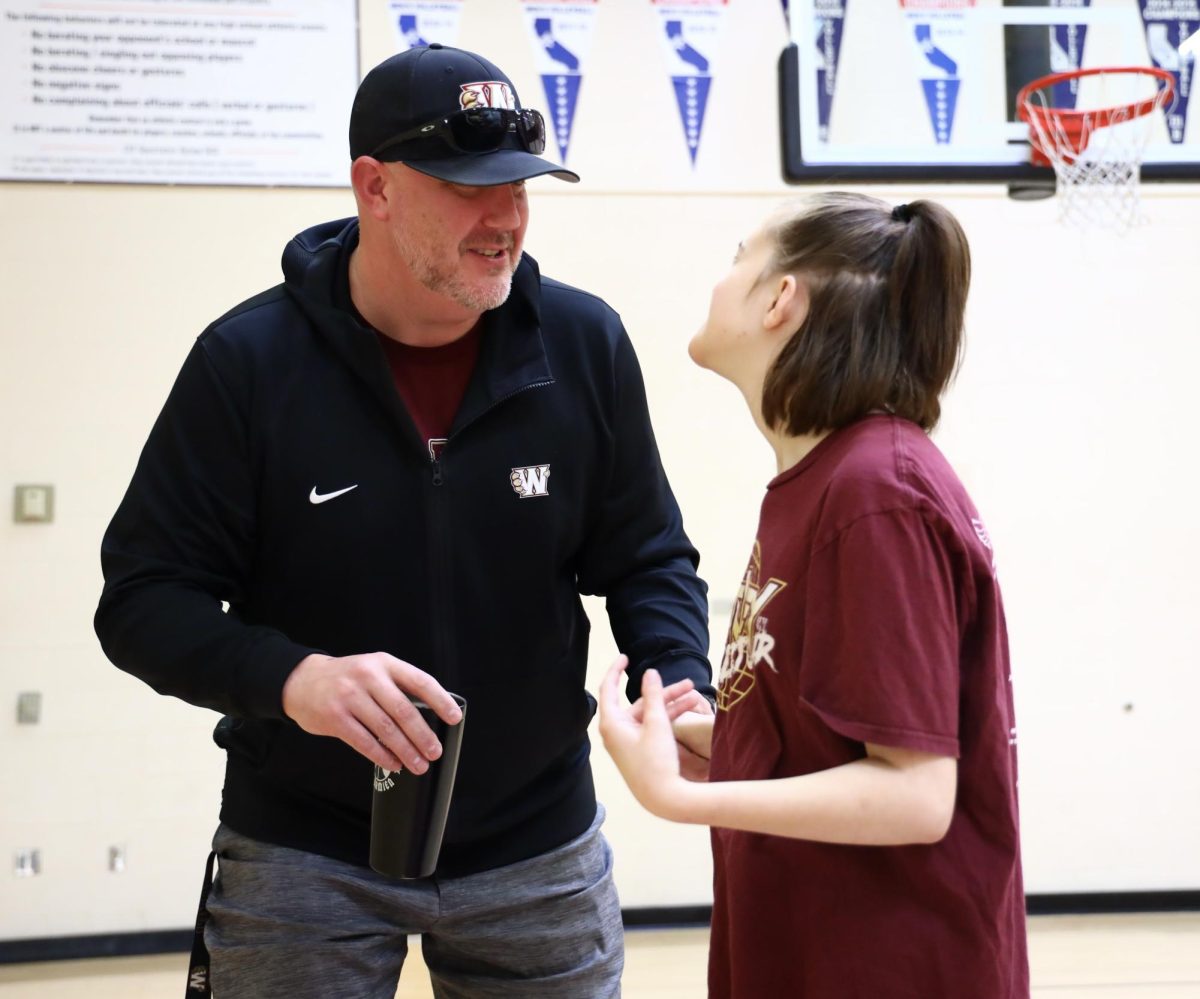 In second period Unified Sports, Mr. Nick French talks to Bella Pool. French resigned from the athletic director position March 13 to be more present with the classes he teaches, like Unified Sports, as well as be available for his family and the basketball program, for which he is head men’s varsity coach. Mr. Erich Means has been hired as the new athletic director for the 2024-25 school year. Photo by Isabella Tomasini