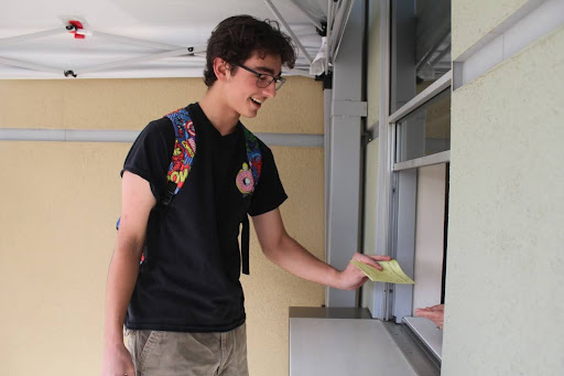 Before school, Dylan Stoffle picks up a pass to excuse him out of class for an appointment later in the day April 12. A large number of students on campus left school every day this year for various reasons, which affects the attendance rate and fosters chronic absenteeism.