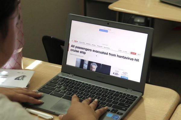 Scrolling through her computer during AP Language Arts class in D7, Audrey Iman reads a CNN news article on the recent Hantavirus outbreak, stemming from a quarantined cruise ship anchored in Cape Verde. Photo by Lila Combs.
